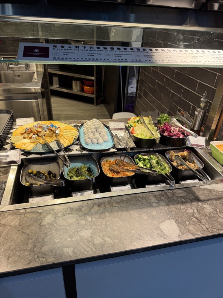 Buffet counter — hot dishes, salad station, and Asian pastries